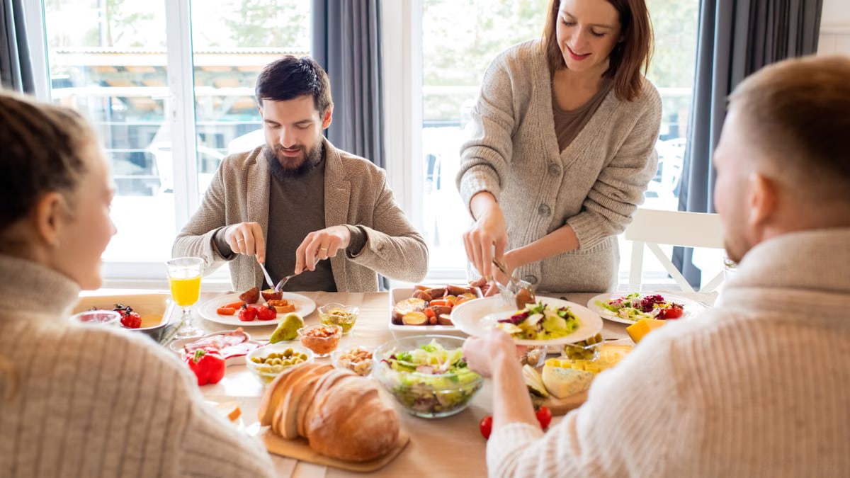 Four friends sharing a delightful meal indoors, highlighting friendship and togetherness.